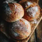 sourdough buns recipe with golden crust on wooden board