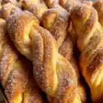 Sourdough discard cinnamon twists on a wooden board