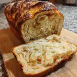 Apple cinnamon sourdough bread sliced with golden crust and swirl