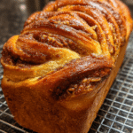 Pumpkin sourdough bread with pecans on wooden board