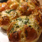 Freshly baked sourdough discard garlic rolls in cast iron