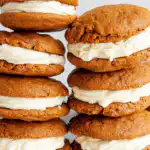 Sourdough pumpkin whoopie pies stacked on rustic fall table