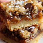Salted Caramel Sourdough Cookie Bars stacked with gooey caramel