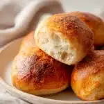 Sourdough discard rolls fresh out of the oven on a rustic tray