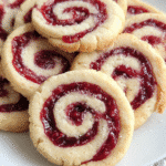 Raspberry swirl shortbread cookies on rustic tray